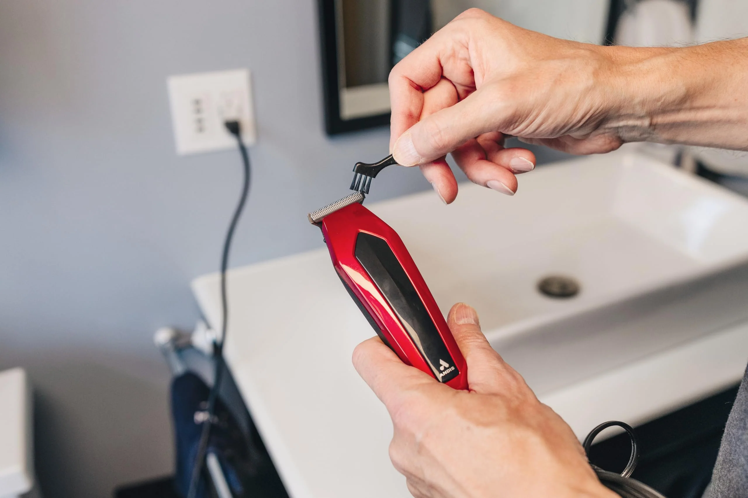 Andis 562940 Ultra Clip Corded Clipper & Trimmer 15-PieceHair Cutting Combo Kit, Stainless Steel Blades, Power Pivot Motor, Whisper Quiet, Hanger Loop, Red - Image 4